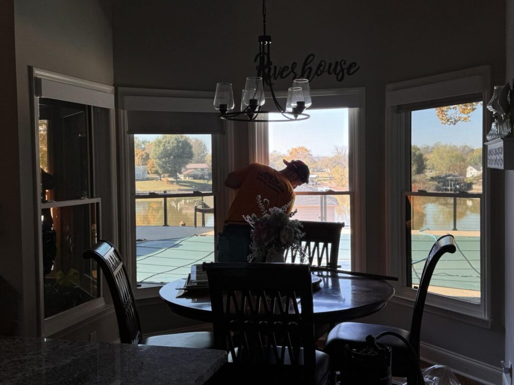 Worker tinting kitchen windows | Tennessee Film Solutions