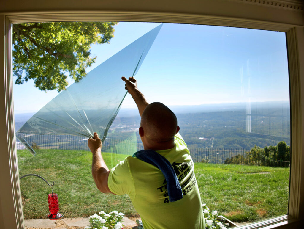 Worker upgrading home with window tinting | TN Film Solutions, Home Window Tinting